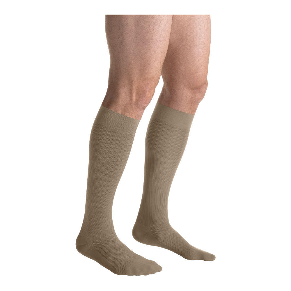 A close-up of legs in khaki-colored JOBST knee-high closed-toe compression stockings.