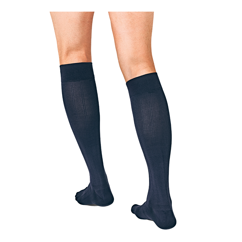Close-up back view of two legs wearing JOBST For Men Explore navy compression socks.