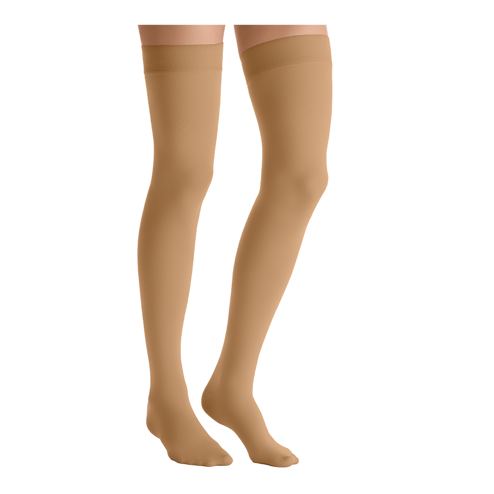 Close-up side view of a person wearing JOBST Opaque thigh-high compression stockings in tan.
